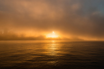 Sun light and warm ray of light through the fog.