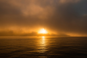 Sun light and warm ray of light through the fog.