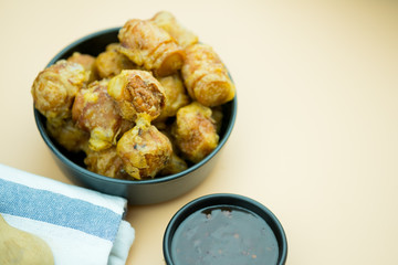 Deep fried meatball served with sweet sauce.