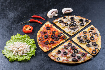 Assorted pizza slices. Margherita, pepperoni, four cheese pizza. Top view. Different types of pizza on the textured old wooden table.