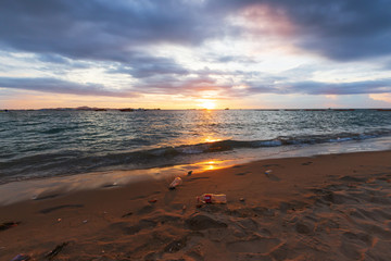 Garbage on the beach in sunset light