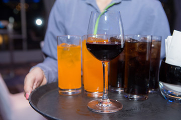 Glass drinks  on the waiter's tray