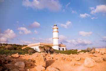 Fototapeta na wymiar Lighthouse on a rocky beach in Mallorca