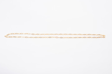 Gold chain necklace isolated on white background.