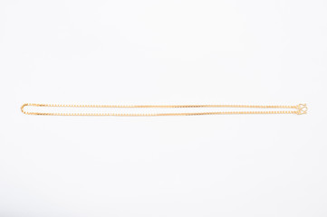 Gold chain necklace isolated on white background.