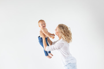 Single parent, motherhood and babyhood concept - Mother holding sweet baby girl on white background with copy space