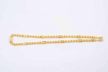 Gold chain necklace isolated on white background.