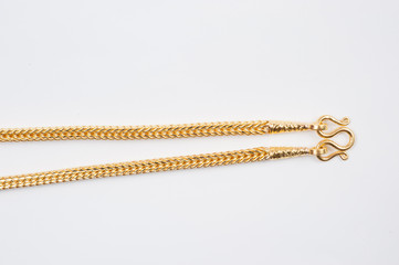 Gold chain necklace isolated on white background.