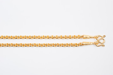 Gold chain necklace isolated on white background.