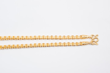 Gold chain necklace isolated on white background.