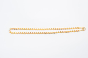 Gold chain necklace isolated on white background.