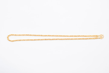 Gold chain necklace isolated on white background.