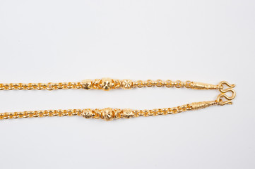 Gold chain necklace isolated on white background.