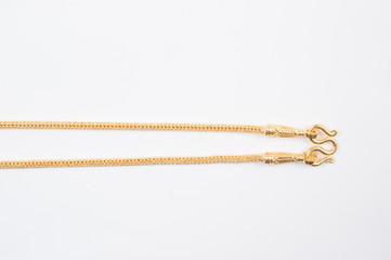 Gold chain necklace isolated on white background.