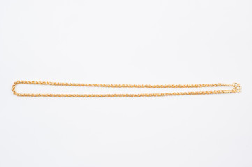 Gold chain necklace isolated on white background.