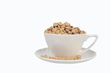 Raw coffee beans in coffee cup on open space.