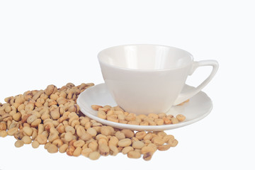 Raw coffee beans in coffee cup on open space.