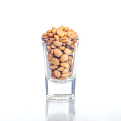 Fresh Raw coffee beans in glassware on background.