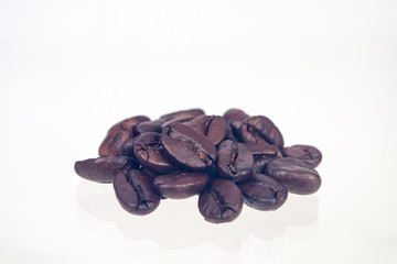 Fresh roasted beans on white background.