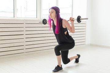 Fototapeta na wymiar Fitness, sport, people concept - young woman in sport suit is squatting with bar