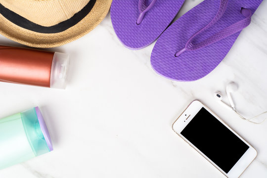 Smartphone, flip-flops, sunscreen and hat.