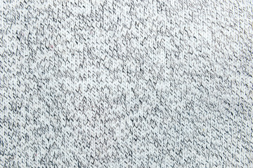 Black and White handmade knitted fabric. Knitting or knitted pattern texture with close up view. Picture with grain and color from film simulation filter. 