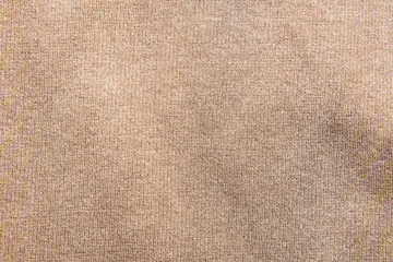 Brown clothing fabric texture background. Top view of cloth textile surface. Picture with grain and color from film simulation filter. 