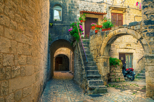 Fototapeta Beautiful street view with rustic houses in Trogir, Dalmatia, Croatia