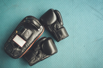 Black practise boxing gloves in the boxing gym
