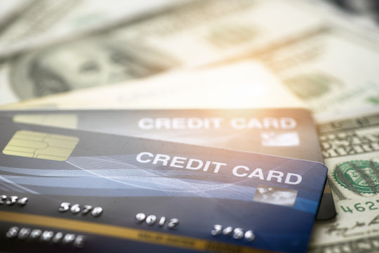 close up and selective focused of credit card on banknote background