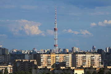 Fototapeta na wymiar Kiev, Ukraine - July 8, 2019: TV Tower made of steel. The antenna of television centre in Kiev (Kyiv) on the residential buildings background