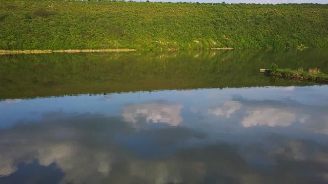 Flying over the river on a sunny summer day. Dniester river of Moldova republic.