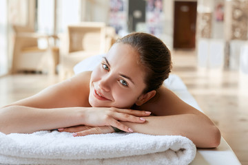 Obraz na płótnie Canvas Portrait of young beautiful woman in spa environment. Body care. Spa body. Cosmetology. Massage