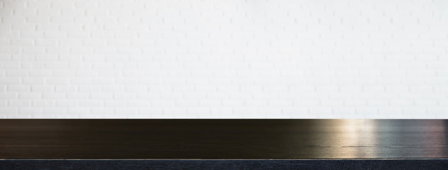 Empty office wood table with white brick wall and copy space.