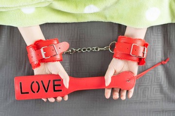 Adult sex toy with female hand in sexual health care concept.