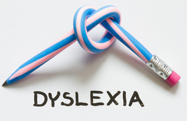 Dyslexia words and curved pencil - obrazy, fototapety, plakaty