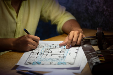 Interior designer works on a hand drawing sketch using color pencils