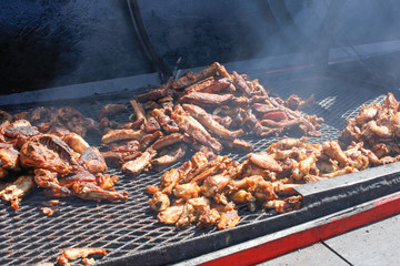A big grill featuring an array of cooked meat