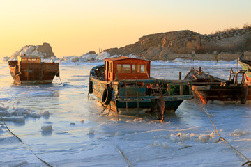 wooden boat in sea ice