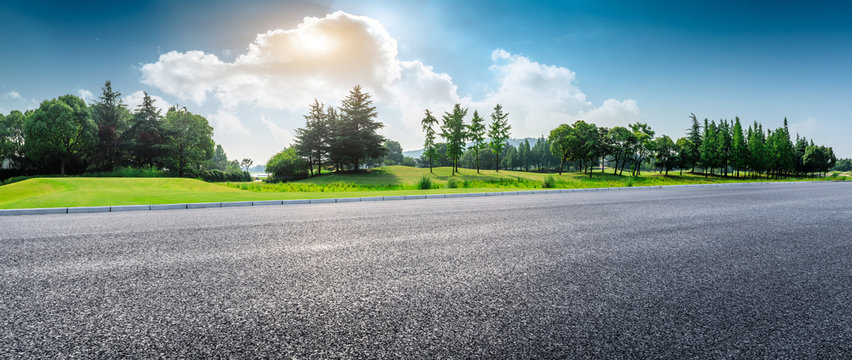 Country asphalt road and green woods nature landscape in summer