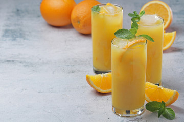 Glasses full of orange juice with ice	