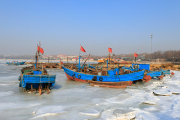 Fototapeta na wymiar Wooden fishing boats in the ice