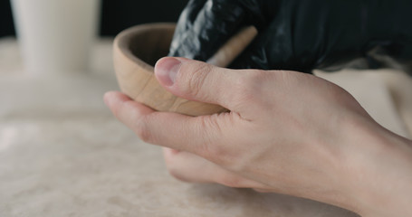 woodworker applying oil finish to olive wood bowl
