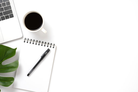 Flat lay, top view office table white desk. Workspace with notepad, pen, green leaf, and coffee cup on white background. - Powered by Adobe