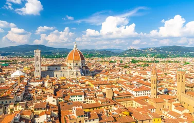 Fototapete Florenz Top aerial panoramic view of Florence city with Duomo Cattedrale di Santa Maria del Fiore cathedral, buildings houses with orange red tiled roofs and hills range, blue sky white clouds, Tuscany, Italy