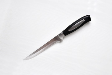 Kitchen cook knife on a white table