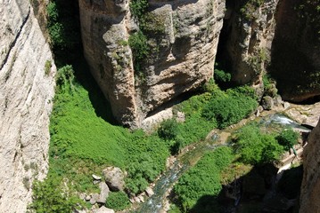 View looking down on the river at the bottom of the gorge during the Springtime, Ronda, Andalusia, Spain.