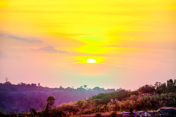 Obraz premium Beautiful dramatic sunset on the top of mountains. Landscape mountain with orange sunset sky clouds