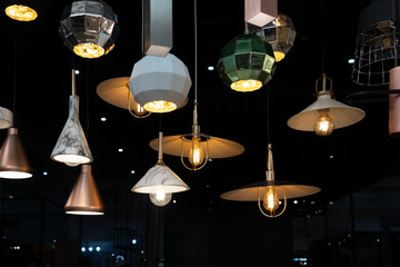 Many hanging lamps displayed in a showroom
