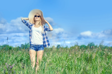 happy beautiful girl in the blooming field enjoying the sun and flowers. concept freedom and expression